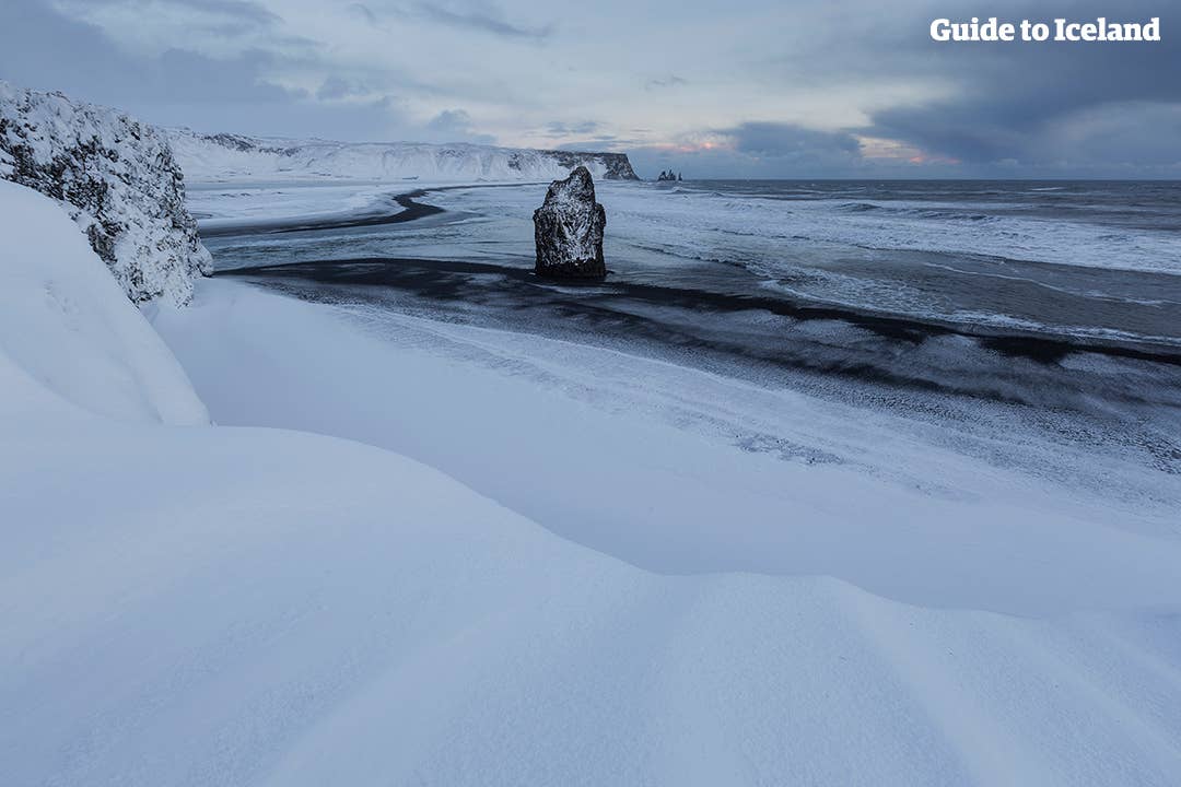 Reynisfjara beach covered by a soft, white winter blanket.