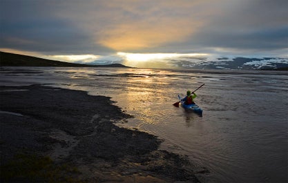 Kayaking under the midnight sun in the Hornstrandir region of the Westfjords.