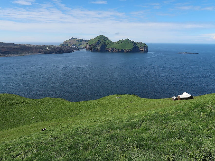 Bjarnarey Island is visible from Heimaey, the only populated landmass in the Westman Islands.