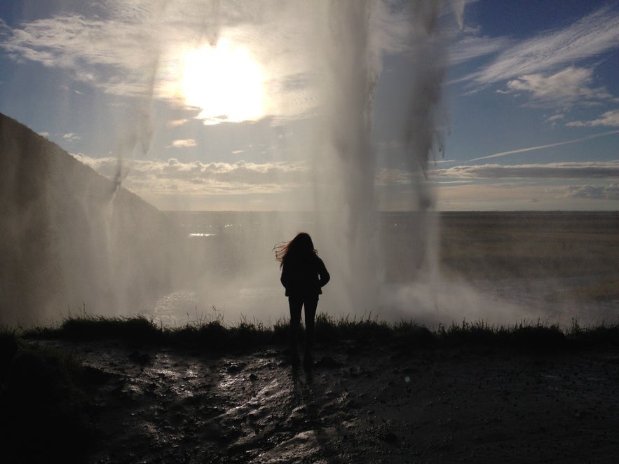 Standing behind Seljalandsfoss waterfall in Iceland