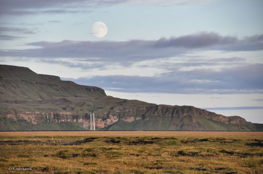 Supermoon over Seljalandsfoss waterfall in south Iceland