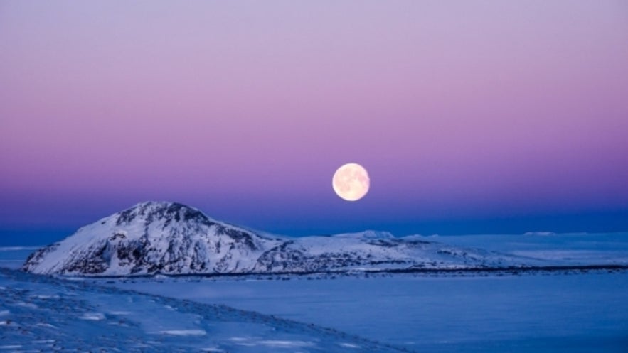 Supermoon over Icelandic winter landscape by Mike Moore