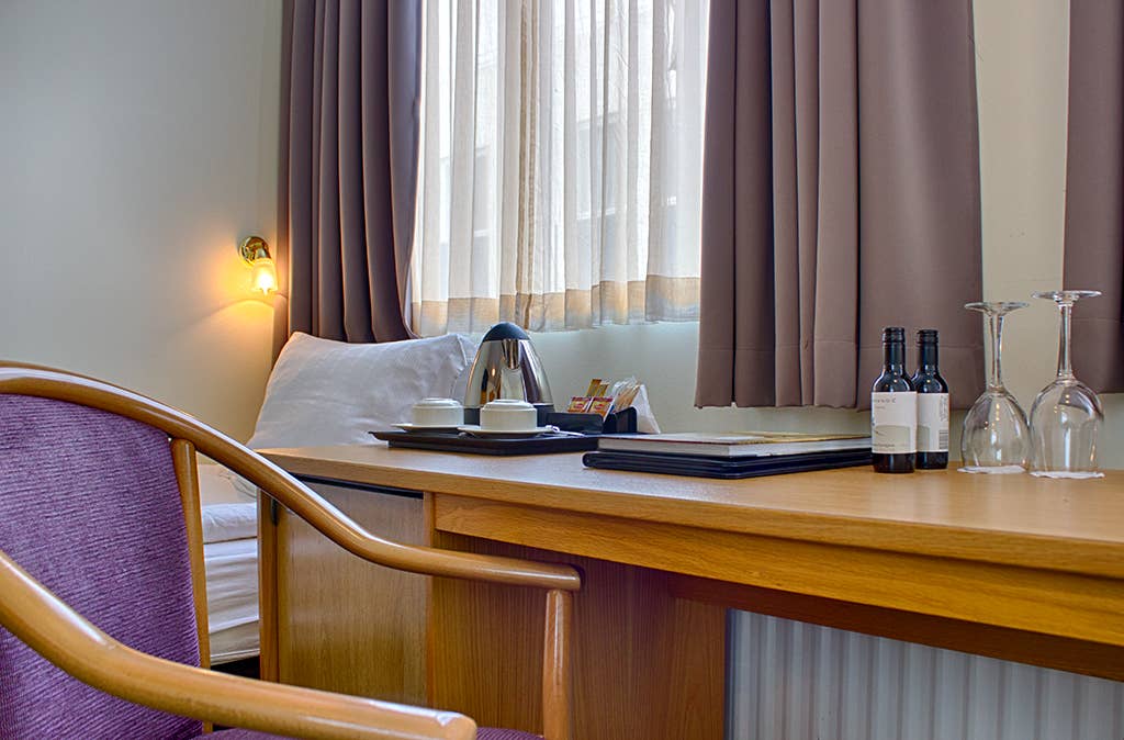 The minibar and table have complimentary coffee and tea.