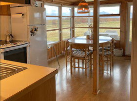 The dining area with fantastic views through the large windows in Hestaland Horse Farm Cottage.