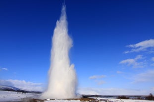 Take a photo of an erupting geyser in the Geysir geothermal area.