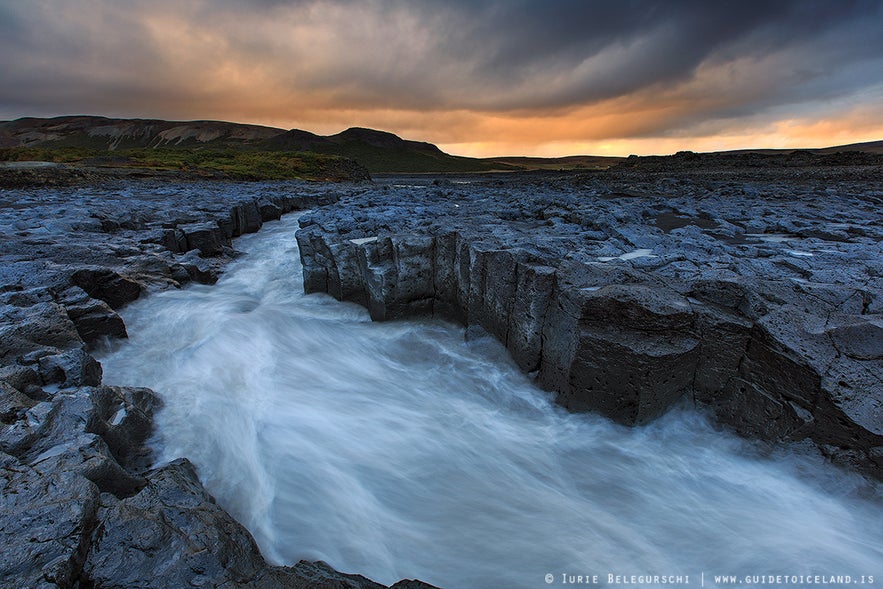 One of Iceland's rivers races through a valley of black lava.