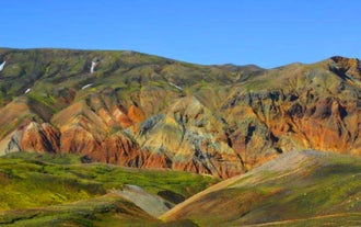 The rugged mountains at Landmannalaugar in the Icelandic Highlands are colored in vibrant greens, reds, and yellows, a photographer’s dream.