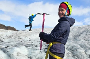 Adventurers posing for a fun photo while exploring the Solheimajokull glacier.