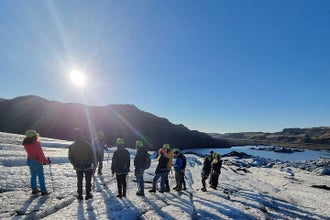 A group of hikers on the icy terrain of Solheimajokull glacier.