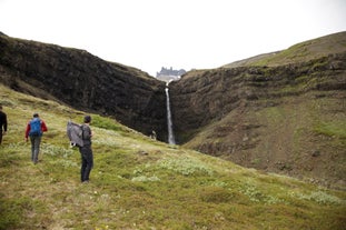 A magnificent waterfall with a stunning rock formation on the horizon.