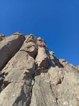 A person scales a rock face on a rock-climbing tour in Iceland.