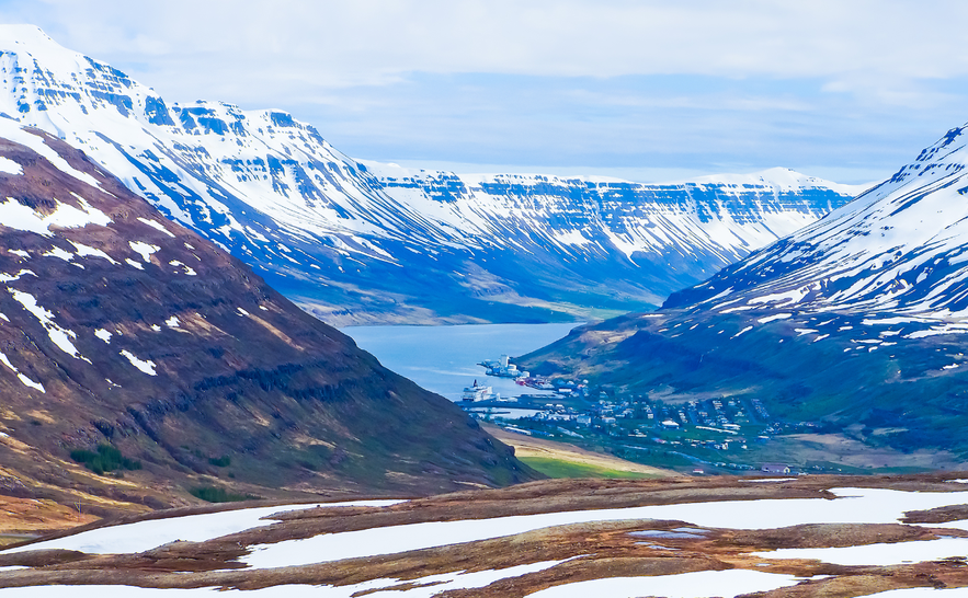 The fjords of Seydisfjordur where you can see the mountain blue in the distance