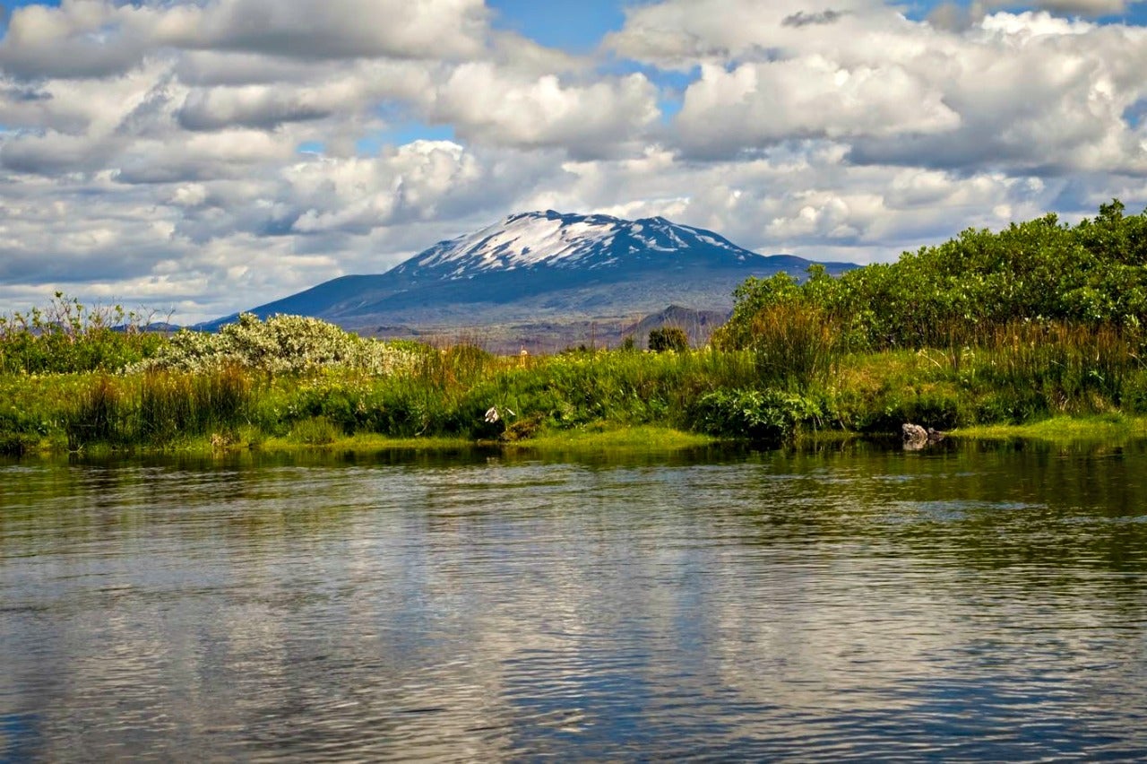 A lush valley frames Hekla volcano in South Iceland.