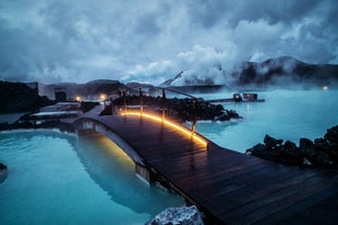 A bridge leads over the waters of the Blue Lagoon geothermal spa.
