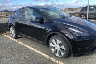 A black vehicle in a parking space.