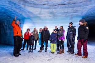 A group of tourists is touring inside the Langjokull ice cave.