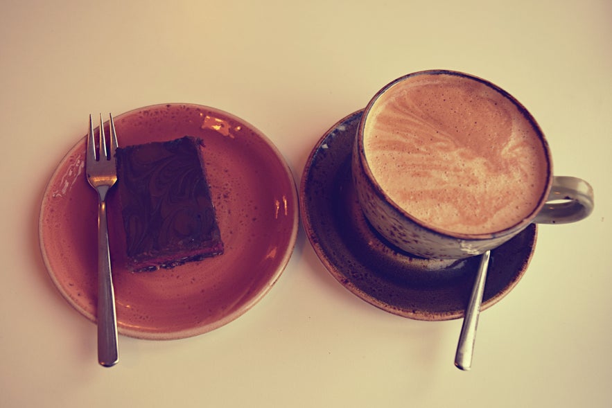 Raw vegan raspberry brownie with vegan latte at Glo