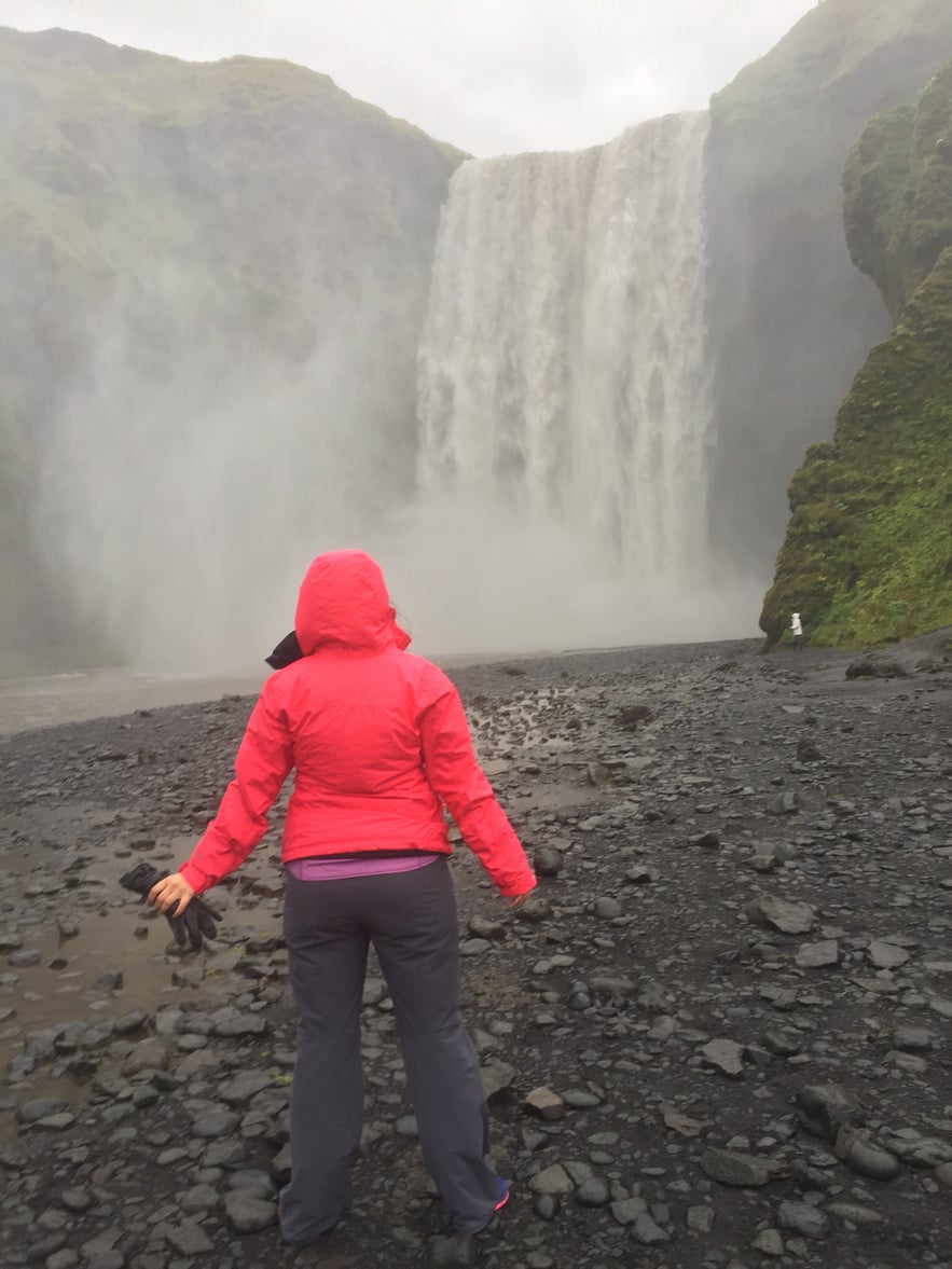 Standing in front of one of the many incredible waterfalls in Iceland