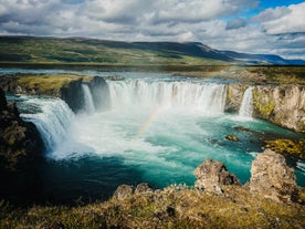 The Godafoss waterfall creates a curtain of mist and rainbows on sunny days.