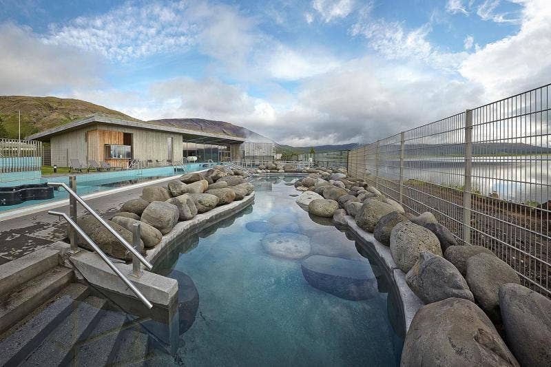 Outdoor pool at Krauma Geothermal Baths near Deildartunguhver in West Iceland, showing nudity in Iceland bathing culture.