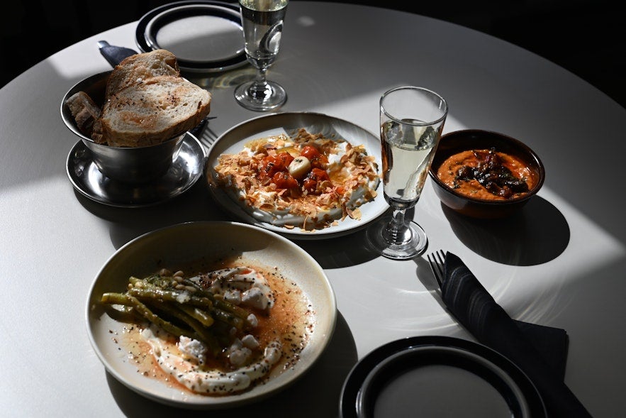 Bread slices and vegetables served in bowls at Litli Barinn in Reykjavik.
