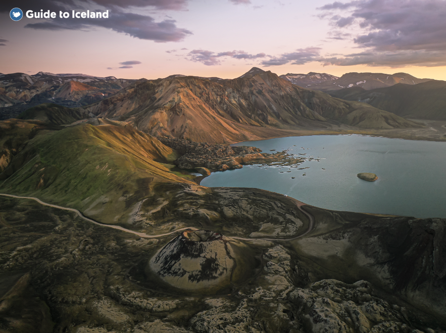 Aerial view of Frostastadavatn Lake near Landmannalaugar, Iceland, with rhyolite mountains and volcanic craters at sunset.