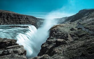 The massive Gullfoss waterfall flows down a narrow canyon.