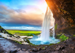 A waterfall cascades into a plunge pool in South Iceland.