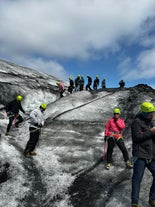 Guests are equipped with the necessary safety gear for walking on the Solheimajokull glacier.