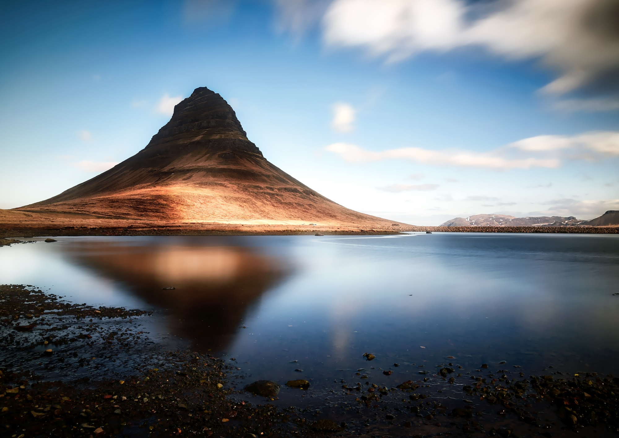Kirkjufell Mountain reflecting in calm water near Grundarfjordur on the Snaefellsnes Peninsula.