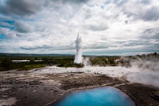 Strokkur geyser erupts with boiling water every few minutes.