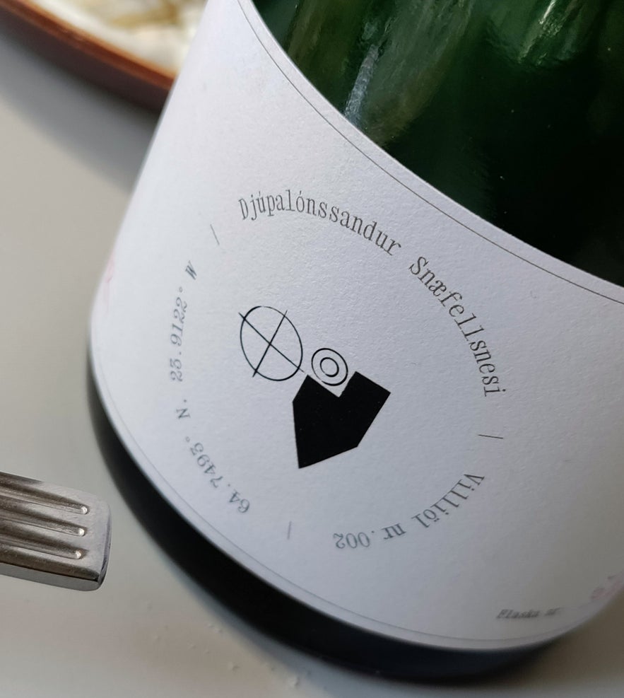 Close-up of a wine bottle labeled Djupalonssandur Snaefellsnesi served at Litli Barinn. Close-up of a wine bottle labeled Djupalonssandur Snaefellsnesi served at Litli Barinn.