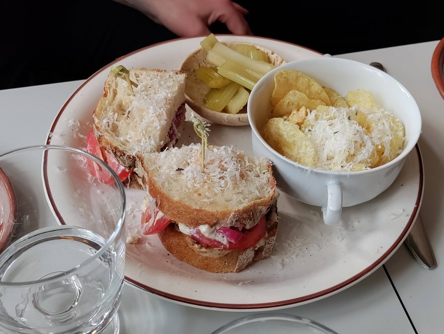 Sandwich plate with crisps, pickles, and parmesan-topped tomato sandwiches at Litli Barinn. Sandwich plate with crisps, pickles, and parmesan-topped tomato sandwiches at Litli Barinn.