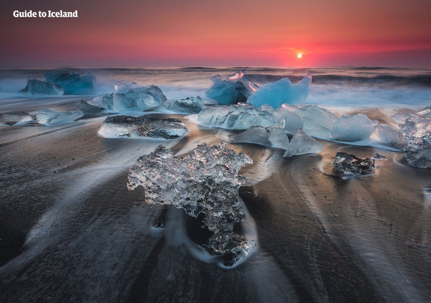 Glistening icebergs melting in the Diamond Beach.