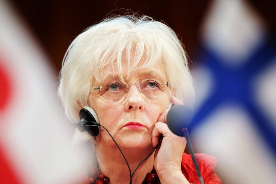 Jóhanna Sigurðardóttir standing at a podium during the Nordic Council session in Stockholm 2009, captured in a serious expression.
