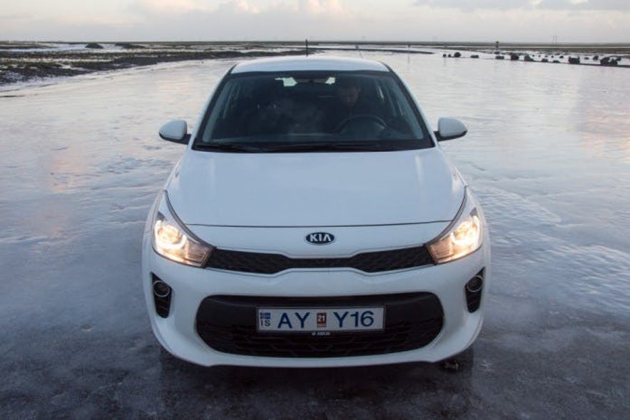 Picture of a icy parking place in Iceland. Icy road conditions are something you should really be prepared for when you consider renting a car in Iceland.