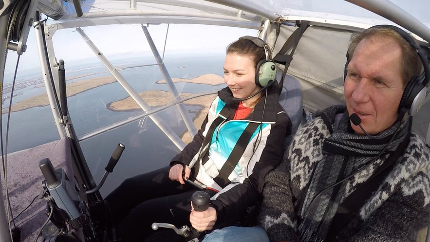 A passenger and a pilot in an UltraLight Buddy Aircraft.