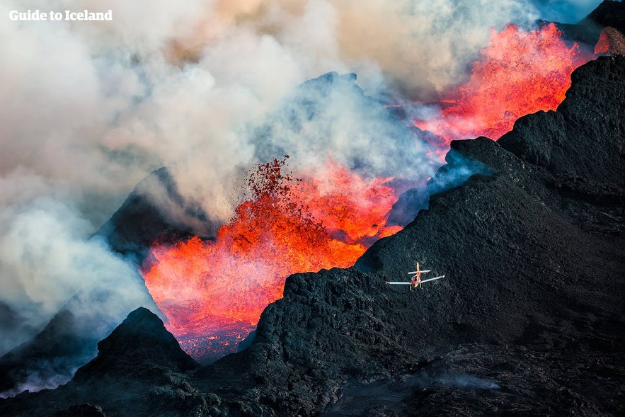 A light aircraft flying over eruptions at Holuhraun Lava fields.