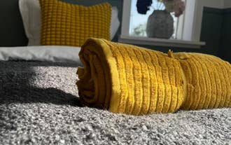 Close up of rolled towels on a bed at Floki by Guesthouse Reykjavik