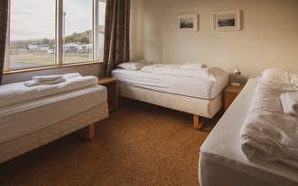 A triple room in Hostel Framtid, with three single beds and a window.