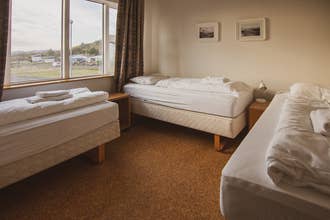 A triple room in Hostel Framtid, with three single beds and a window.