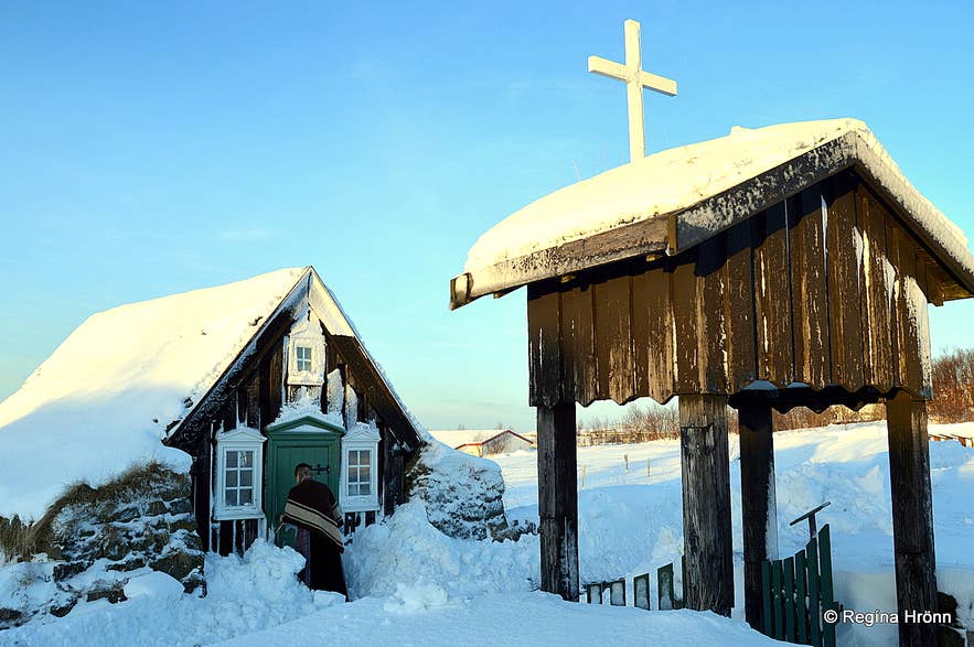 Snow-covered turf vestry and church gate at Arbaejarsafn Open-Air Museum in Reykjavik.