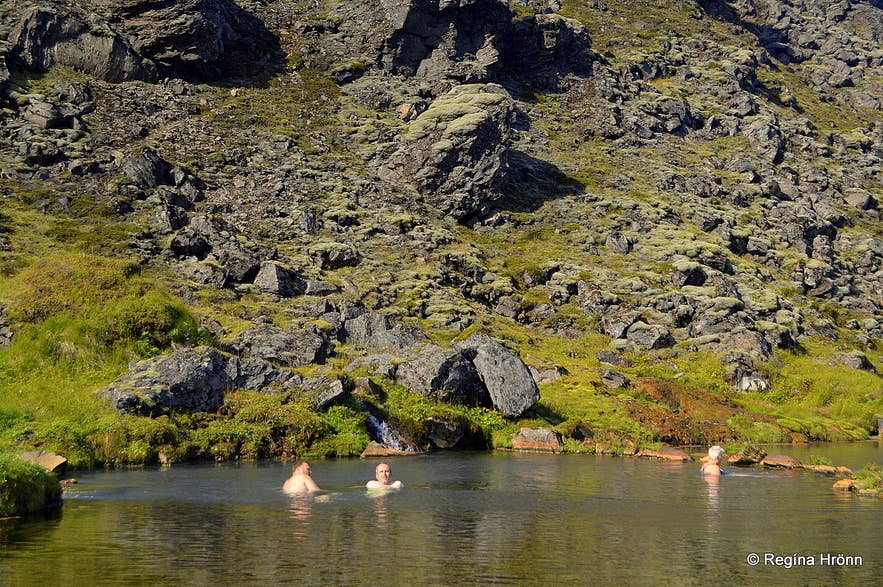 Bathers soaking in the natural hot pool at Landmannalaugar below the Laugahraun Field.