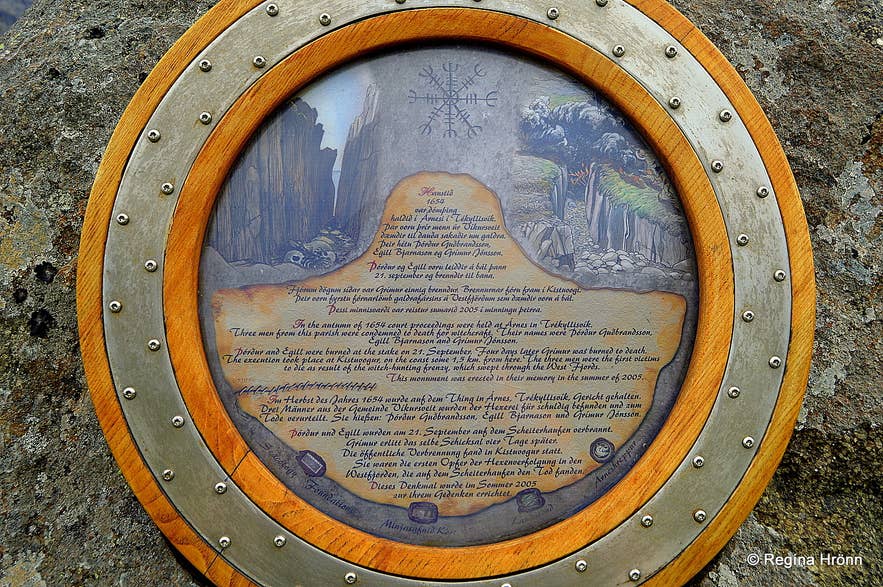 Circular memorial plaque set in stone at the Westfjords, engraved with an Aegishjalmur stave and Icelandic text commemorating the 1654 witch-hunt trials.