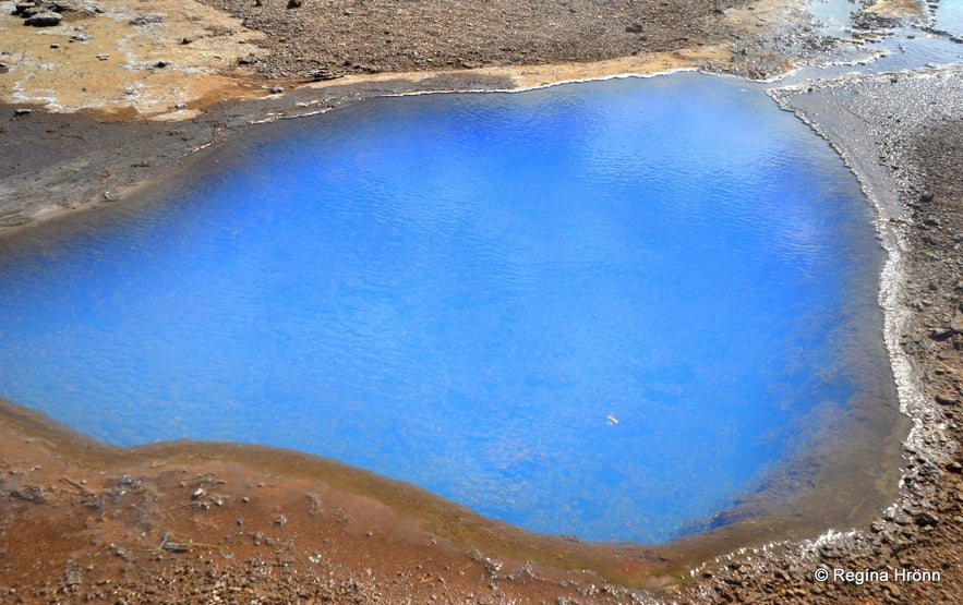 Blue pool of hot geothermal water in Geysir geothermal area in southwest Iceland.