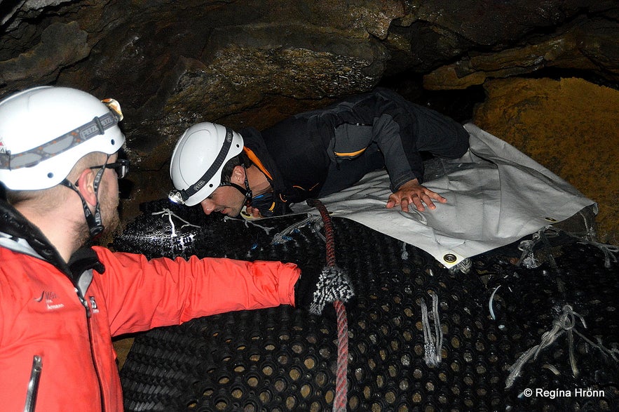 Squeezing through the entrance to Lofhellir cave