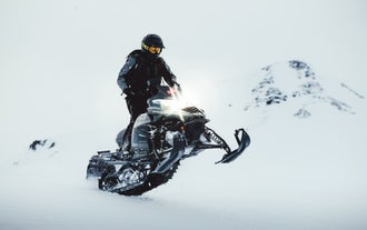 A man on a snowmobile during the Langjokull glacier tour.