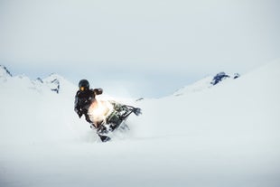 A person maneuvering their snowmobile at Langjokull glacier.