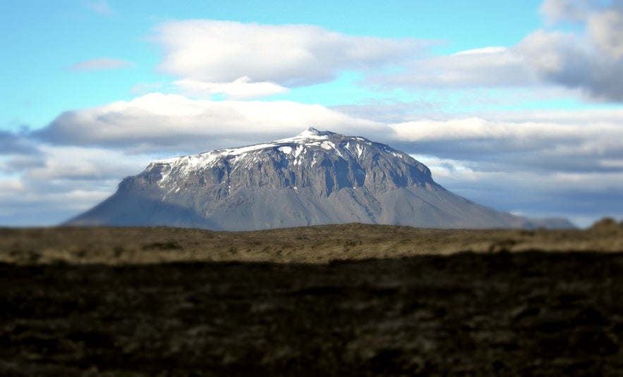 Herðubreið is a tabletop mountain surrounded by a lava field.