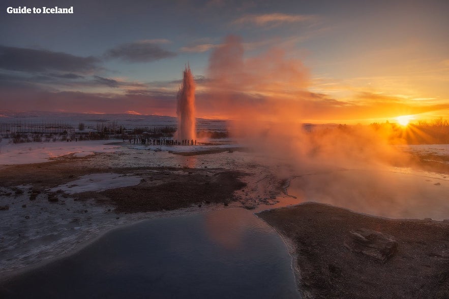 Strokkur purkautuu auringonlaskussa.